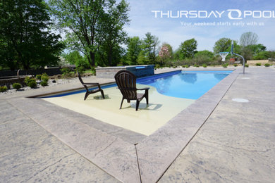 Example of a large backyard stamped concrete and rectangular pool design in Atlanta