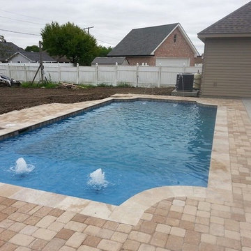 Project: West Bank. Noche travertine coping, bubbler jet fountains on tanning L