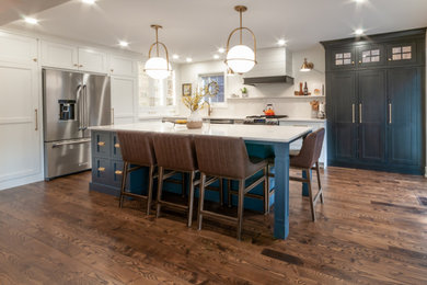 Eat-in kitchen - large l-shaped medium tone wood floor and brown floor eat-in kitchen idea in Toronto with an undermount sink, beaded inset cabinets, white cabinets, quartz countertops, white backsplash, quartz backsplash, stainless steel appliances, an island and white countertops