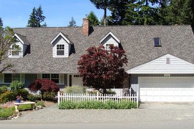 Photo of a large two-storey grey exterior in Seattle with wood siding, a hip roof and a shingle roof.
