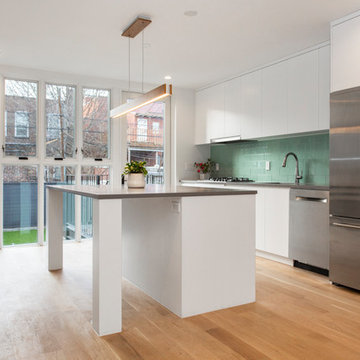 White Modern Kitchen with Green Tile Backsplash