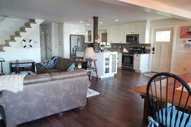 Inspiration for a timeless l-shaped medium tone wood floor and brown floor eat-in kitchen remodel in Other with a farmhouse sink, beaded inset cabinets, white cabinets, quartz countertops, gray backsplash, stainless steel appliances, matchstick tile backsplash and an island