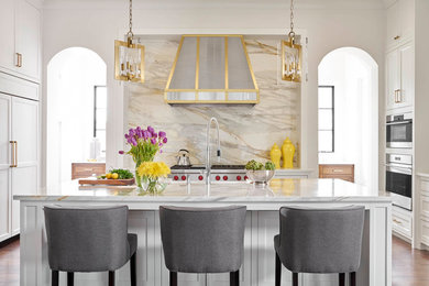 Tuscan u-shaped dark wood floor and brown floor kitchen photo in Dallas with an island, shaker cabinets, white cabinets, gray backsplash and stone slab backsplash