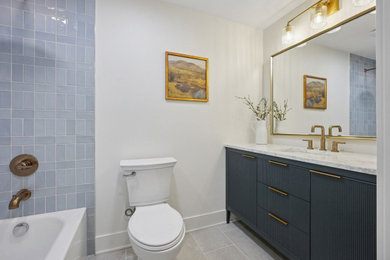 Example of a small kids' blue tile and ceramic tile porcelain tile, gray floor and single-sink bathroom design in Columbus with blue cabinets, a one-piece toilet, white walls, an undermount sink, quartz countertops, white countertops and a freestanding vanity