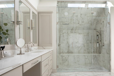Example of a large transitional master porcelain tile porcelain tile, double-sink and vaulted ceiling bathroom design in Milwaukee with gray cabinets, an undermount sink, quartz countertops, a hinged shower door and a built-in vanity