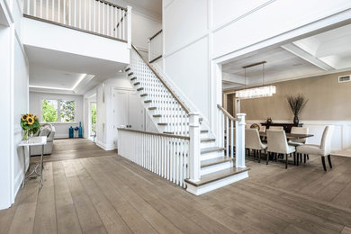Example of a mid-sized classic wooden straight wood railing staircase design in New York with painted risers