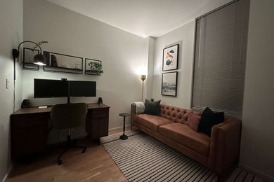 Inspiration for a small industrial freestanding desk light wood floor and brown floor study room remodel in Chicago with white walls