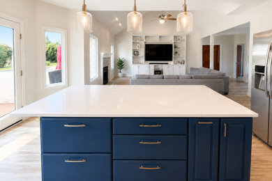 Example of a mid-sized trendy l-shaped open concept kitchen design in Indianapolis with raised-panel cabinets, blue cabinets, quartzite countertops, an island and white countertops