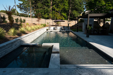 Inspiration for a mid-sized contemporary backyard stone and rectangular lap hot tub remodel in Raleigh
