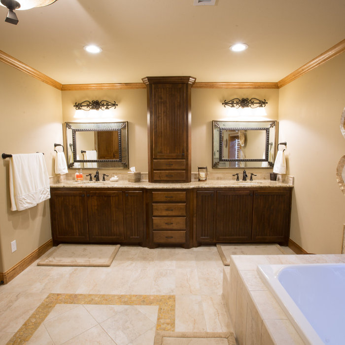 Drop-in bathtub - large traditional master limestone floor drop-in bathtub idea in Dallas with dark wood cabinets, beige walls, an undermount sink and granite countertops