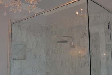 Example of a large transitional master multicolored tile and stone tile mosaic tile floor corner shower design in Denver with an undermount sink, flat-panel cabinets, white cabinets, marble countertops, a one-piece toilet and gray walls