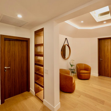 Skylit Hall With Walnut Doors and Shelving