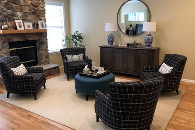 Inspiration for a large timeless open concept light wood floor family room remodel in Philadelphia with beige walls, a standard fireplace, a stone fireplace and no tv