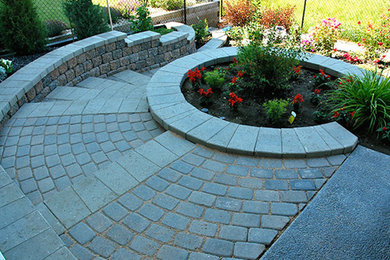 Photo of a mid-sized transitional shade backyard brick landscaping in Calgary for spring.