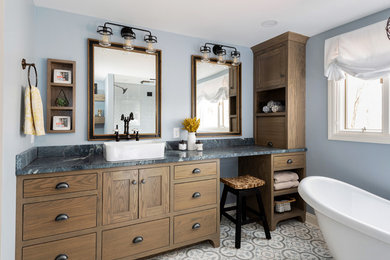 Inspiration for a large transitional master bathroom in Other with shaker cabinets, medium wood cabinets, a freestanding tub, an alcove shower, blue walls, porcelain floors, a vessel sink, marble benchtops, multi-coloured floor, a hinged shower door and blue benchtops.