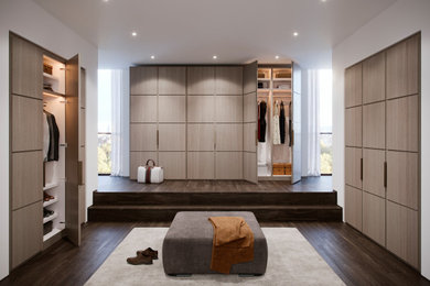 This is an example of a large contemporary wardrobe in London with dark hardwood flooring and brown floors.