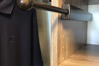 Inspiration for a transitional carpeted walk-in closet remodel in Other with flat-panel cabinets and gray cabinets
