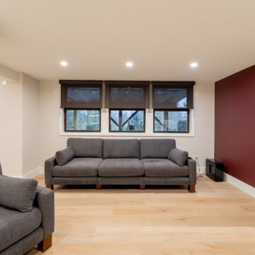 Contemporary Basement Lounge with Custom Built-ins and Accent Wall
