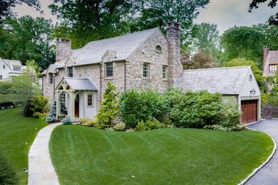 Traditional gray two-story stone exterior home idea in New York with a shingle roof and a gray roof