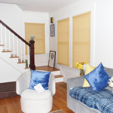 Window treatments in a white living room and kitchen