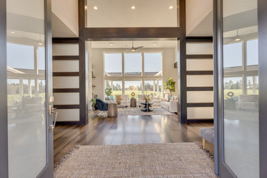 Example of a transitional entryway design in Portland with a glass front door