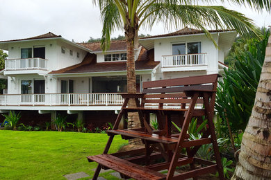 Mid-sized contemporary white two-story concrete fiberboard house exterior idea in Hawaii with a hip roof and a shingle roof