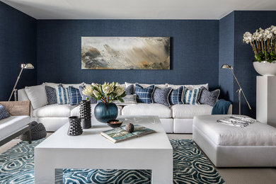 Large transitional walk-out gray floor basement photo in Miami with blue walls