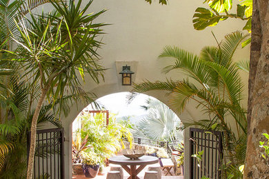 Inspiration for a tropical patio in Other with brick pavers.