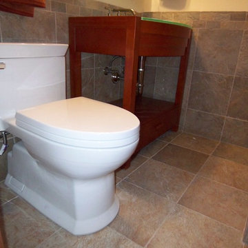 Easy to clean concealed trapway Toto toilet with stylish and cohesive tile on fl