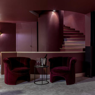 Photo of a contemporary basement in Moscow with red walls, carpet and grey floors.