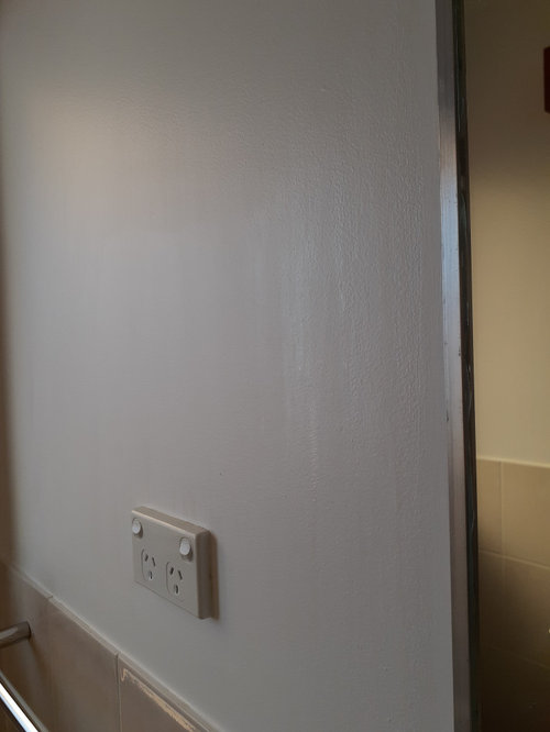 wet area ceiling and walls painted with ceiling white showing streaks