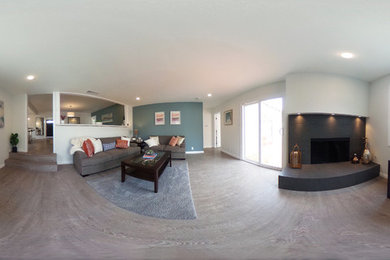 Mid-sized minimalist enclosed medium tone wood floor living room photo in Los Angeles with white walls, a corner fireplace and a tile fireplace