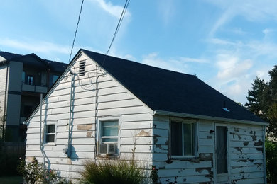 Example of a small minimalist white one-story exterior home design in Portland with a shingle roof