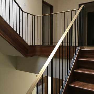 Walnut Stairs with Bronze Handrail and Iron Balusters