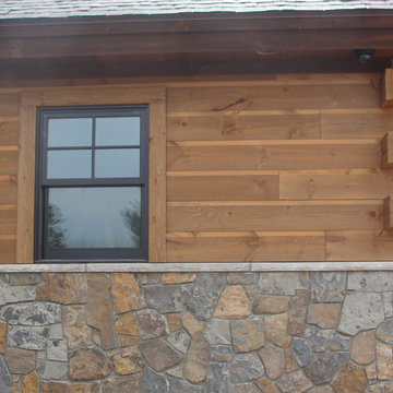 Combine Adirondack siding, butt-and-pass corners, rough sawn trim and stonework