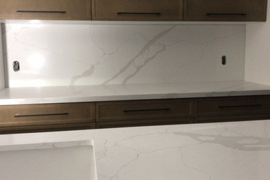 White Polished Kitchen Countertop - with Custom brown cabinetry