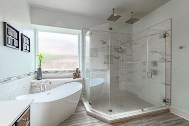 Mid-sized trendy master white tile and porcelain tile vinyl floor, brown floor and double-sink bathroom photo in Dallas with raised-panel cabinets, medium tone wood cabinets, a two-piece toilet, white walls, an undermount sink, quartz countertops, a hinged shower door, white countertops, a niche and a built-in vanity