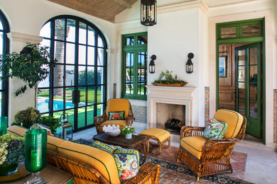 Example of a large tuscan concrete floor sunroom design in Miami with a standard fireplace, a stone fireplace and a standard ceiling