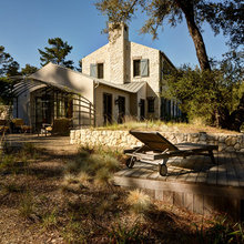 metal pergola, wood deck with hotter, stone walls