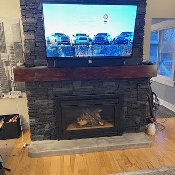 Iron Ore Stacked Stone Electric Fireplace and TV Wall