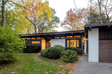 Inspiration for a mid-sized 1950s multicolored one-story mixed siding exterior home remodel in Other
