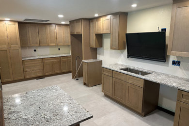 Inspiration for a mid-sized timeless l-shaped porcelain tile and white floor eat-in kitchen remodel in Denver with an undermount sink, shaker cabinets, medium tone wood cabinets, granite countertops, an island and multicolored countertops