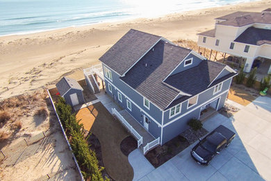 Inspiration for a large beach style two-storey blue exterior in Other with concrete fiberboard siding and a gable roof.