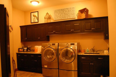 This is an example of a galley laundry room in Chicago with a side-by-side washer and dryer.