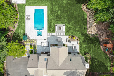 Design ideas for a large modern full sun backyard concrete paver landscaping in Other with a fire pit.