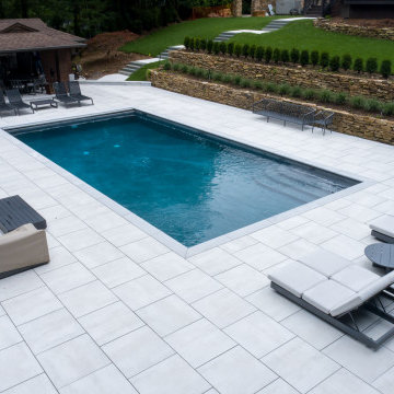 Pool Deck with Elegant Porcelain Pavers and Marble Copings