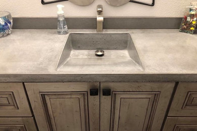 Concrete vanity tops with integrated ramp sinks
