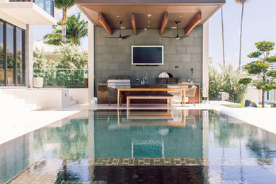 Inspiration for a contemporary rectangular pool remodel in Miami with a bbq area