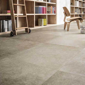 Modern living room library with large cement look porcelain tile