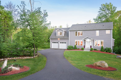 Inspiration for a large contemporary gray two-story vinyl exterior home remodel in Boston with a shingle roof